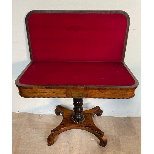 25 - A REGENCY ROSEWOOD CARD TABLE, with crossbanding to top, decorative brass inlay to frieze, opening t... 