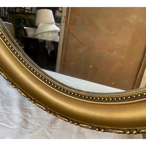 26 - A PAIR OF DECORATIVE OVAL GILT OVERMANTLE MIRRORS, with beading to gilt frame, bow mounting to top w... 