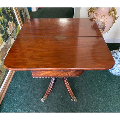 34 - A REGENCY MAHOGANY FOLD-OVER TEA TABLE, with raised carving and beading to the frieze above turned a... 