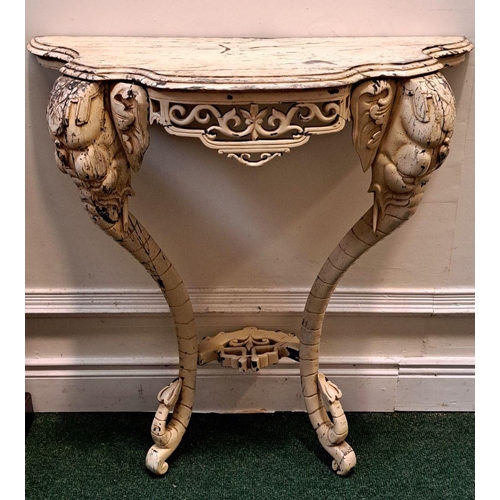 35 - AN ELEPHANTINE PAINTED ROCOCO CONSOLE TABLE bevelled top, with floral fretwork on the frieze; distin... 