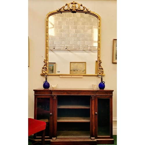 38 - A VERY FINE CARVED GILTWOOD WALL MIRROR / OVER MANTLE MIRROR, to the arch is a scrolling foliage car... 