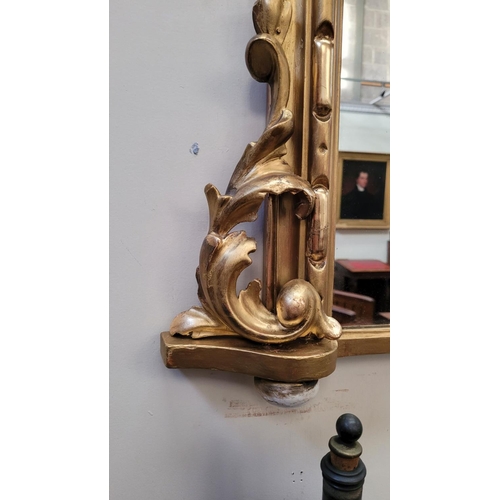 38 - A VERY FINE CARVED GILTWOOD WALL MIRROR / OVER MANTLE MIRROR, to the arch is a scrolling foliage car... 