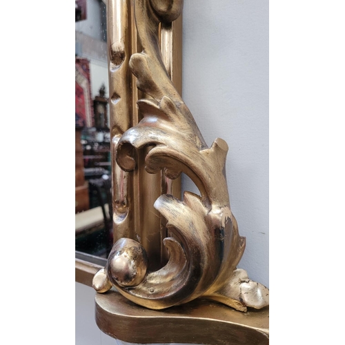 38 - A VERY FINE CARVED GILTWOOD WALL MIRROR / OVER MANTLE MIRROR, to the arch is a scrolling foliage car... 