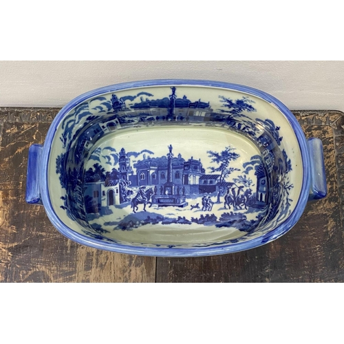 40 - AN IRONSTONE BLUE AND WHITE FOOTBATH/PLANTER, with painted scenes surrounding as well as to interior... 