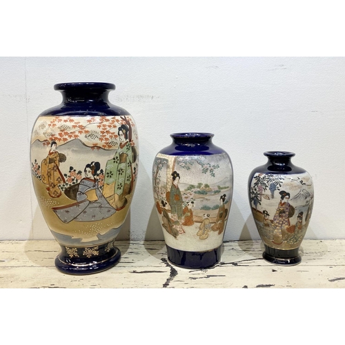 47 - THREE GRADUATED 20TH CENTURY SATSUMA VASES, each with gilded decoration on painted panels depicting ... 