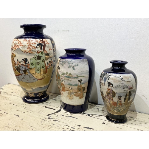 47 - THREE GRADUATED 20TH CENTURY SATSUMA VASES, each with gilded decoration on painted panels depicting ... 