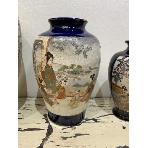 47 - THREE GRADUATED 20TH CENTURY SATSUMA VASES, each with gilded decoration on painted panels depicting ... 