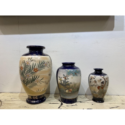 47 - THREE GRADUATED 20TH CENTURY SATSUMA VASES, each with gilded decoration on painted panels depicting ... 