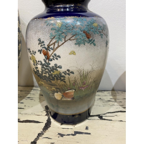 47 - THREE GRADUATED 20TH CENTURY SATSUMA VASES, each with gilded decoration on painted panels depicting ... 