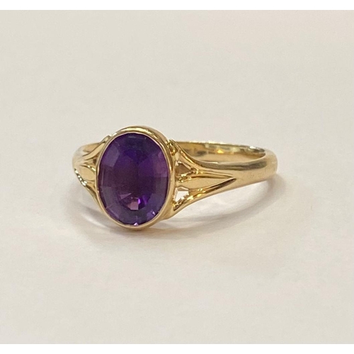 48 - AN ELEGANT 14CT YELLOW GOLD BEZEL AMETHYST RING, oval cut amethyst bezel set with split shank design... 