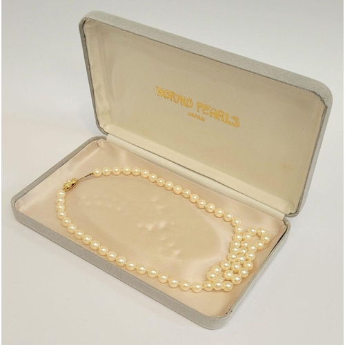 61 - A SINGLE STRAND PEARL NECKLACE, with nice decorative gilt metal clasp, cased in a Noriko Pearl box. ... 