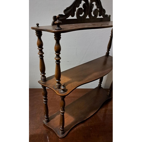 72 - A FLORAL VICTORIAN THREE-TIER MAHOGANY SPINDLE HANGING SHELF,  acanthus carving to the top, with spi... 