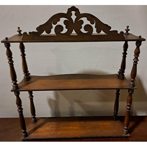 72 - A FLORAL VICTORIAN THREE-TIER MAHOGANY SPINDLE HANGING SHELF,  acanthus carving to the top, with spi... 