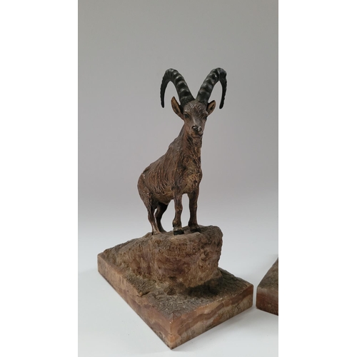 123 - A PAIR OF AUSTIAN MADE COLD PAINTED BRONZE ORNAMENTS OF TWO IBEX STANDING UPON CARVED MINERAL STONE ... 