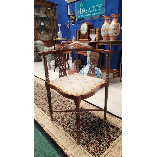 124 - AN EDWARDIAN MAHOGANY INLAID CORNER CHAIR, with raised crest rail decorated with marquetry inlay of ... 