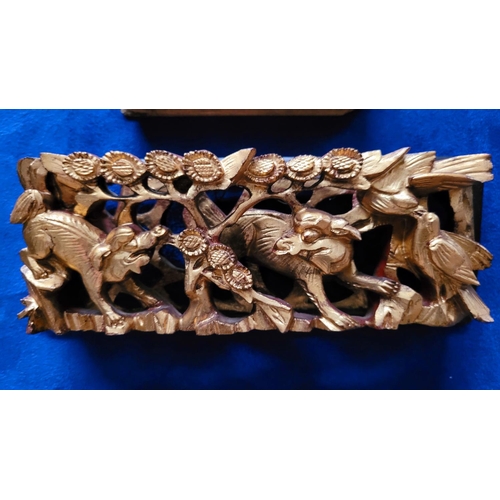 129 - THREE HANDCARVED GILT ASIAN PICTURE PANELS, each depicting a different scene; (i) the top shows a gr... 