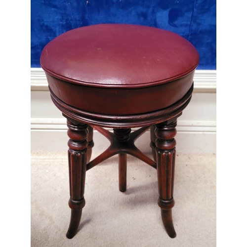 133 - A LATE 19TH CENTURY PIANO / DRESSING STOOL, raised on four turned and broad reeded legs, with splaye... 