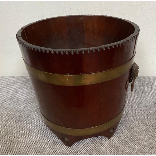 152 - A GOOD QUALITY MAHOGANY BRASS BOUND JARDINERE POT, the tapered barrel shape has cut detail to the ri... 