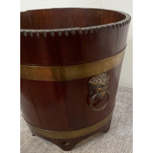 152 - A GOOD QUALITY MAHOGANY BRASS BOUND JARDINERE POT, the tapered barrel shape has cut detail to the ri... 