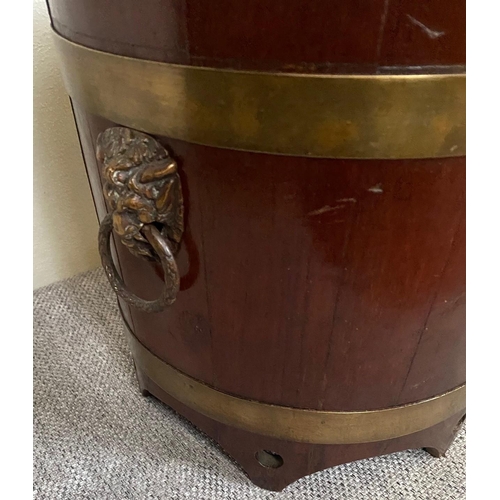 152 - A GOOD QUALITY MAHOGANY BRASS BOUND JARDINERE POT, the tapered barrel shape has cut detail to the ri... 