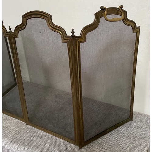 163 - A FOUR PANEL BRASS FRAMED FIRE GUARD, with shaped tops to each panel & hinged so that it can be fold... 