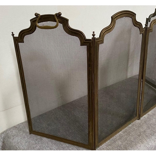 163 - A FOUR PANEL BRASS FRAMED FIRE GUARD, with shaped tops to each panel & hinged so that it can be fold... 