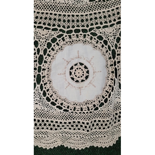 165 - A BEAUTIFUL HAND EMBROIDERED TABLE CLOTH, oval in shape, with a central white panel surrounded by a ... 