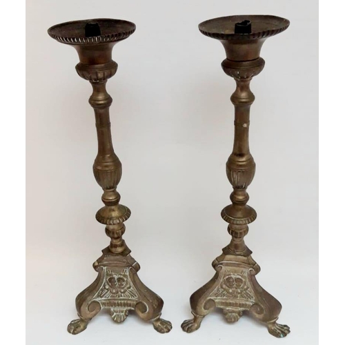 170 - A GOOD QUALITY PAIR OF LARGE GOTHIC STULS BRASS CANDLESTICKS, each base with paw feet and angel or c... 