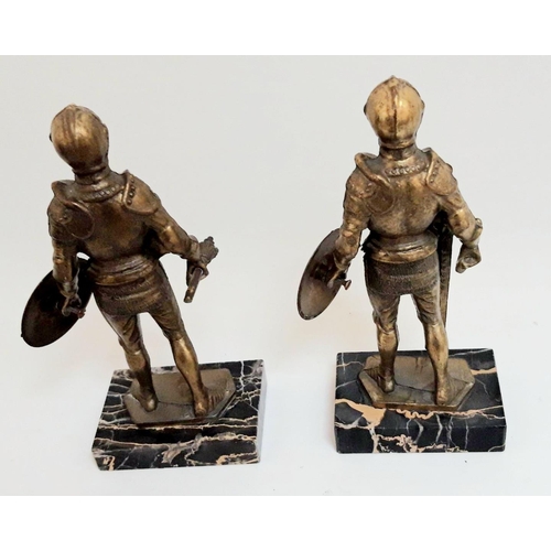 173 - A PAIR OF MID 20TH CENTURY BRASS ORNAMENTS SHOWING TWO KIGHTS IN 16TH ARMOUR, both set on marble bas... 