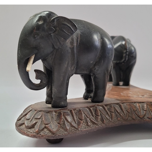 181 - A 19TH CENTURY CARVED ELEPHANT PLATE / BOWL STAND, COMPRISING OF THREE HANDCARVED EBONISED WOODEN EL... 