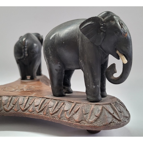 181 - A 19TH CENTURY CARVED ELEPHANT PLATE / BOWL STAND, COMPRISING OF THREE HANDCARVED EBONISED WOODEN EL... 