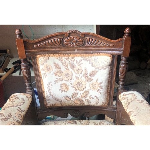 204 - A GOOD QUALITY ANTIQUE CARVED FIRESIDE ARMCHAIR, the back crest rail decorated with a floral & flute... 