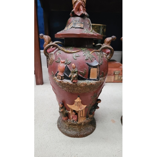 216 - A PAIR OF UNUSUAL HIGH RELIEF JAPANESE / CHINESE STYLE LIDDED URNS, each of baluster shape, with oct... 