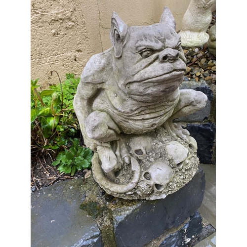 230 - A SMALL GARDEN ORNAMENT IN THE FORM OF A GARGOYLE, 34cm tall.