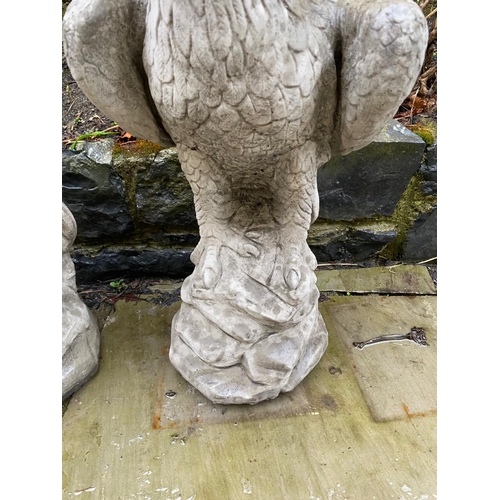 233 - A PAIR OF GARDEN ORNAMENTS OR PIER TOPPERS IN THE FORM OF EAGLES, 59cm tall each.