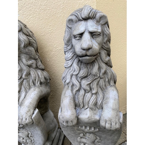 234 - A PAIR OF GARDEN ORNAMENTS IN THE FORM OF TWO LIONS SEATED HOLDING SHIELDS TO THE FRONT, each 86cm t... 