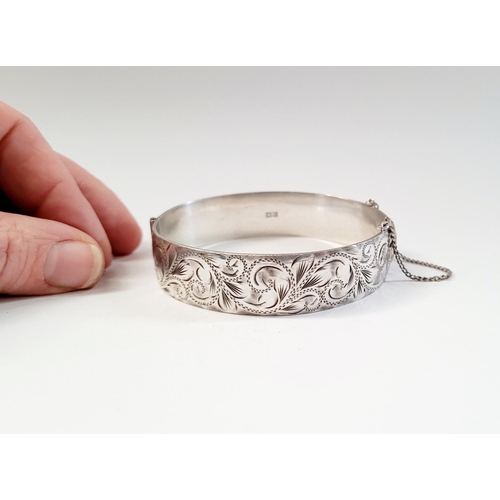 24 - A BEAUTIFULLY DECORATED MID CENTURY SILVER BANGLE/BRACELET, divided into two sections by a hinge, on... 