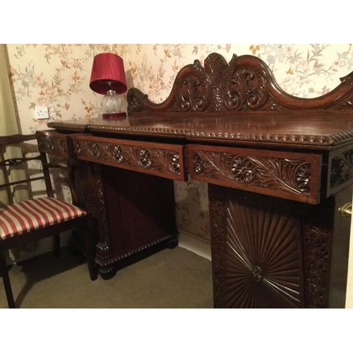 245 - A FANTASTIC ANGLO-INDIAN HAND CARVED MAHOGANY SIDEBOARD, with raised serpentine shaped back gallery ... 