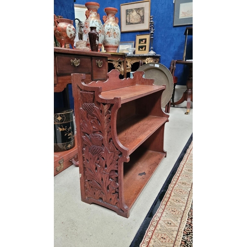 25 - A SCOTTISH ARTS & CRAFTS CARVED OAK THREE TIER SHELF, with beautifully carved side panels showing th... 