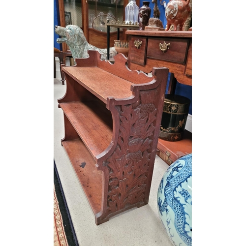 25 - A SCOTTISH ARTS & CRAFTS CARVED OAK THREE TIER SHELF, with beautifully carved side panels showing th... 