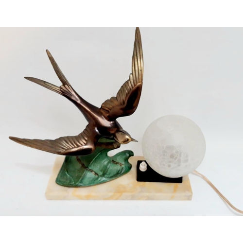 32 - A BEAUTIFUL ART DECO TABLE LAMP, with bronze swallow bird in flight and a glass globe shade for the ... 