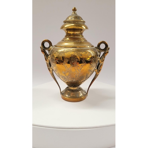 42 - A COLLECTION OF INIDAN BRASS ONAMENTS, including an urn shaped ornament engraved with figural design... 