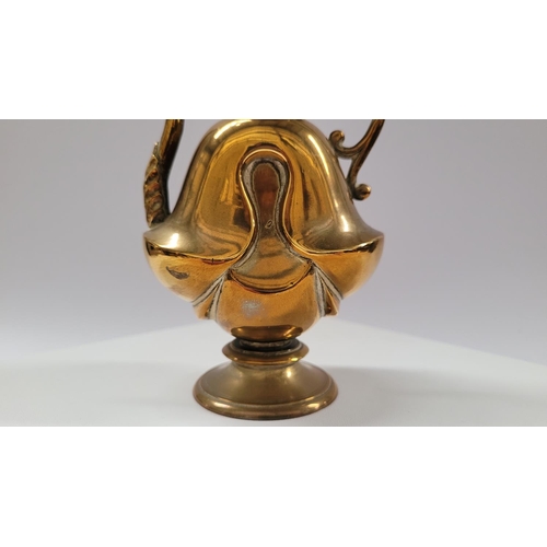 42 - A COLLECTION OF INIDAN BRASS ONAMENTS, including an urn shaped ornament engraved with figural design... 