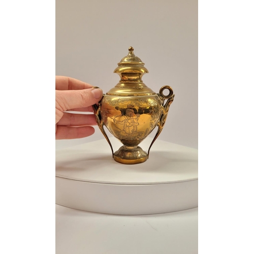 42 - A COLLECTION OF INIDAN BRASS ONAMENTS, including an urn shaped ornament engraved with figural design... 