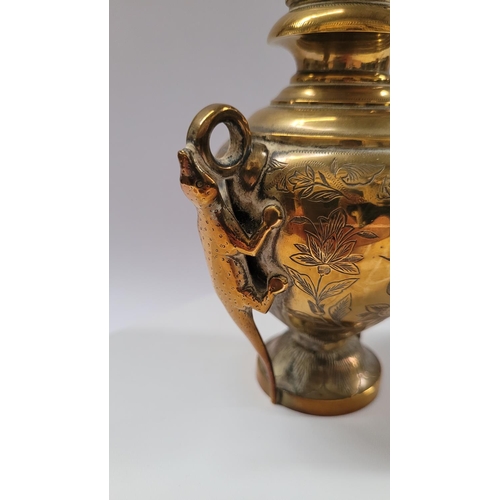 42 - A COLLECTION OF INIDAN BRASS ONAMENTS, including an urn shaped ornament engraved with figural design... 