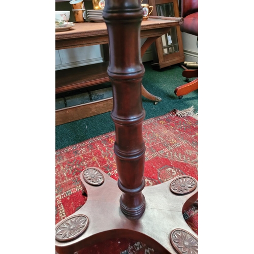 65 - A REGENCY STYLE ROSEWOOD OCCASIONAL TABLE, debossed top with shallow lip on edge, supported by a rin... 