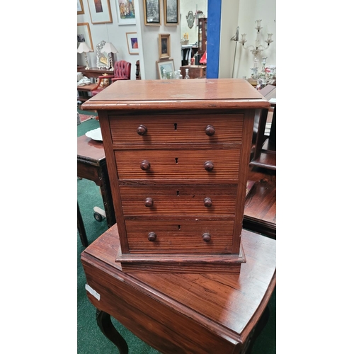 70 - A MINIATURE PINE CHEST OF DRAWERS, the hand crafted miniature chest has four drawers each with a pai... 