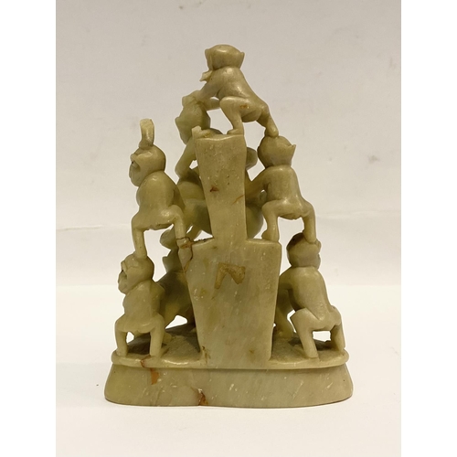 78 - A LATE 19TH CENTURY CHINESE SOAPSTONE CARVING, of a group of monkeys forming a pyramid, light yellow... 