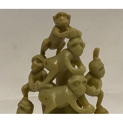 78 - A LATE 19TH CENTURY CHINESE SOAPSTONE CARVING, of a group of monkeys forming a pyramid, light yellow... 