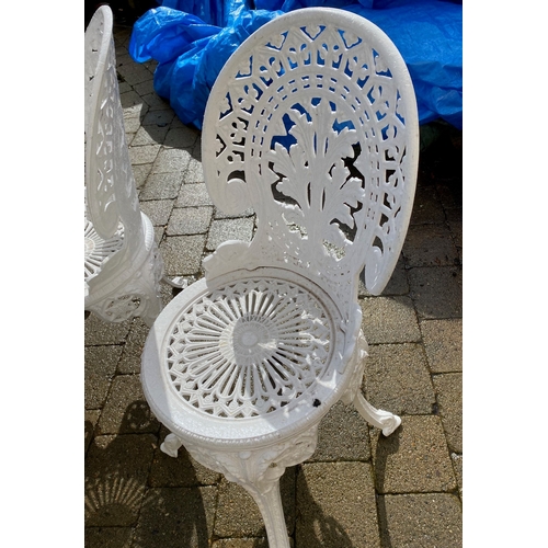 8 - A DECORATIVE CAST IRON GARDEN TABLE WITH CHAIRS, oval table with undertier joined by scrolling feet,... 